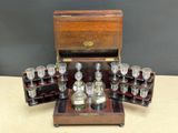 a wooden box with a set of liquor glasses in it