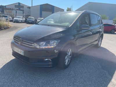 the volkswagen touran is parked in a parking lot in a parking lot