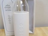 a bottle of water sitting on a table next to a box