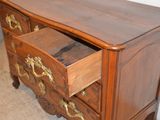 a wooden chest of drawers with gold handles on it
