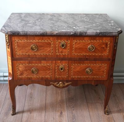 une commode en marbre sur un plancher en bois