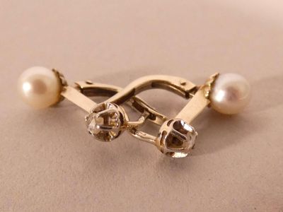 a close up of a ring with pearls on it