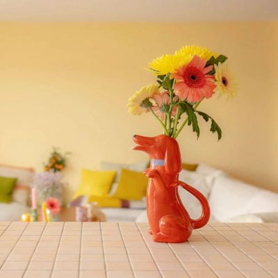 a vase that has flowers in it on a table