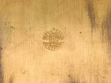a close up of a clock on a wooden surface