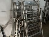 a lot of ladders that are sitting in a garage