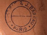a close up of a brown vase with a stamp on it