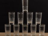 set of six crystal shot glasses on a wooden table