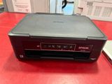 a close up of a printer on a red table in a room