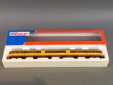 a yellow and orange train in a box on a table