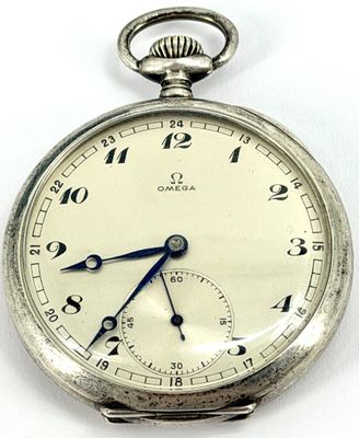 a close up of a silver pocket watch on a white surface