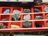 a box full of rocks and minerals on a table