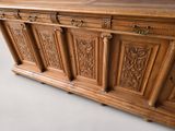 a large wooden cabinet with carvings on the front