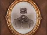 an old picture of a man in a military uniform in a gold frame