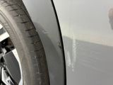 a close up of a car ' s door handle and tire
