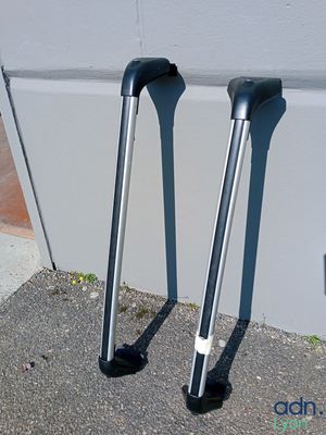 two crutches sitting on the ground next to a wall