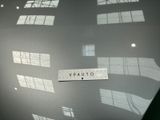 a picture of a sign on a table in front of some windows