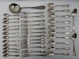 a lot of silver spoons and spoons on the table