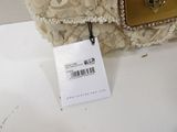a white purse with a tag attached to it