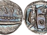 une pièce d'argent sur laquelle figure l'image d'un homme