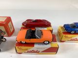several toy cars are sitting on top of boxes on a white surface