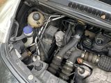 a car with the hood up and the engine in the trunk