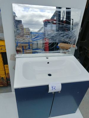 a sink with a mirror on top of it in a store