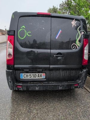 a van with graffiti on the side of it parked on the side of the road