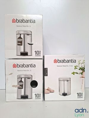three boxes of brabantia trash cans sitting on top of a table