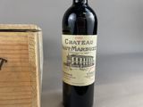 a bottle of wine sitting next to a wooden box