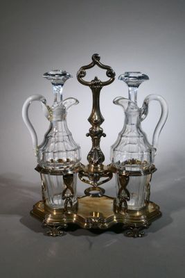 three glass vases sitting on top of a metal stand