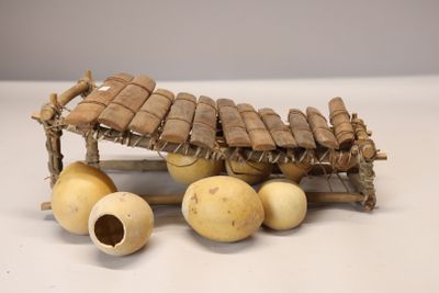 a small wooden structure with a bunch of bananas on top of it