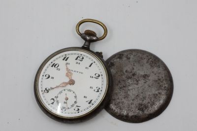 a pocket watch sitting next to a coin on a table