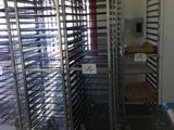 many trays of food that are sitting on a rack