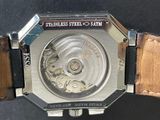 a close up of a watch with a leather band