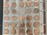 a book with a bunch of coins in it on a table