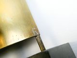 a close up of a pair of scissors cutting a piece of metal