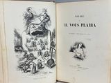 an old book with illustrations on it on a table