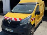 the yellow van is parked in front of a garage