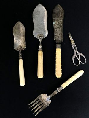 four different types of knives and a pair of scissors