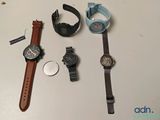 three different watches and a watch on a table