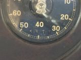 a close up of a clock with a black face