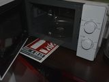 a microwave that is sitting on a table in the kitchen