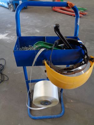 a blue cart with tools and a roll of tape on it