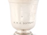 a silver cup on a pedestal that says mr e doyneau