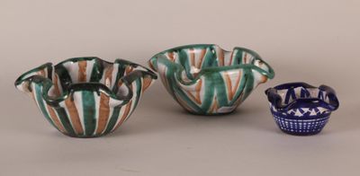 three small vases sitting next to each other on a table
