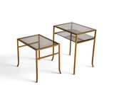 a pair of brass side tables with glass tops