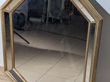 a mirror that is sitting on the ground next to a wall