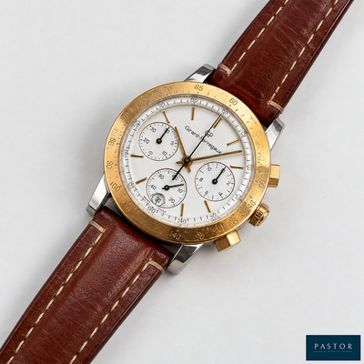 a close up of a watch on a white surface