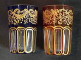 two glasses that are sitting side by side on a table