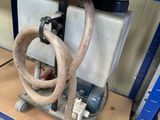 a hose attached to the side of a workbench